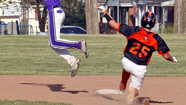 Ironton Fighting TIgers’ Dane Wilson slides safely into second base as Chesapeake’s Josh Hansen leaps high into the air to catch the throw. Ironton won 4-2. (Tim Gearhart of Tim’s News & Novelties, Park Ave. in Ironton)
