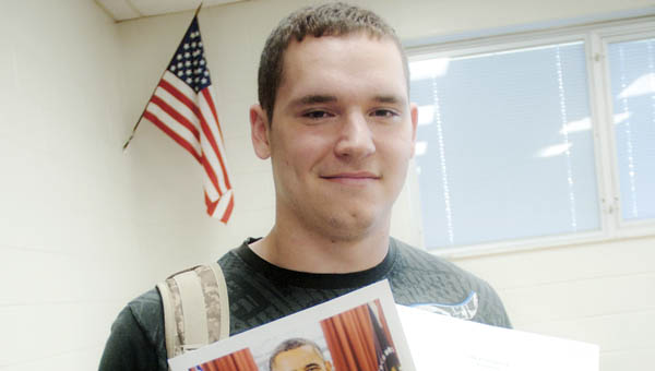 Junior Chase Johnson, at Dawson-Bryant High School, shows off a photograph and written letter sent by President Obama.