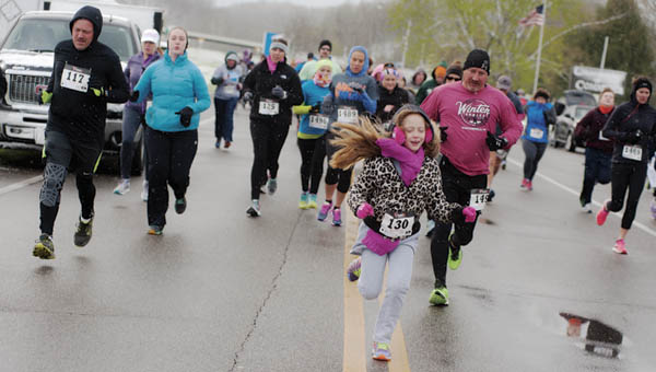 Runners take off at the start of the Sixth Annual 5K for Developmental Disabilities Awareness at The Point industrial park on Saturday morning.