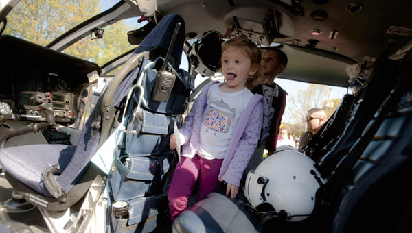 Mayla Wilson makes her way through the HealthNet Aeromedical Services helicopter as part of Transportation Day at Lawrence County Early Childhood Center in South Point Wednesday.