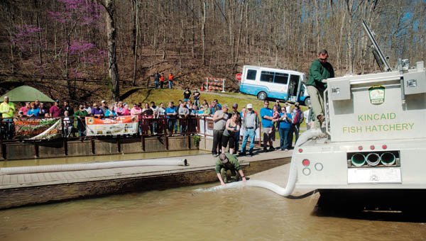 Members of the Ohio Department of Natural Resources get ready to stock Lake Vesuvius following an opening ceremony at the annual Wheelin’ Sportsmen fishing event Thursday.