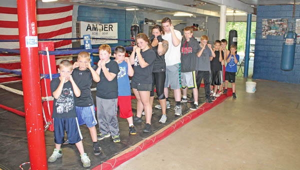 Area children who train and box at the Westwood Boys and Girls Club. From front to back: Steeler Waulk, 8, Bryan Wilburn, 11, Hunter Johnson, 9, Blake Waulk, 11, Amaya Waulk, 15, Alicia Smith (mentor), 33, Bailey Evans, 17, Matt Hogsten, 16, Justin Newcomb, 12, Blake Earnest, 13, Gavin Cordle, 11 and Tyler Earnest, 9.