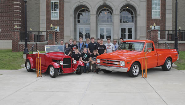 The Ironton High School Auto Tech class stands with the top winning cars from its car show in April. The car on the left won Judge’s Choice, while the truck took Students’ Choice.