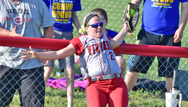 Symmes Valley Lady Vikings’ Hannah Mays crashes into the fence as she robs a possible home run by Portsmouth Clay. Symmes Valley beat Clay 8-1 to win the district title. (Kent Sanborn of Southern Ohio Sports Photos)