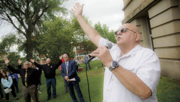 Terry Jones says a prayer during National Day of Prayer on Thursday on the front steps of the Lawrence County Courthouse.