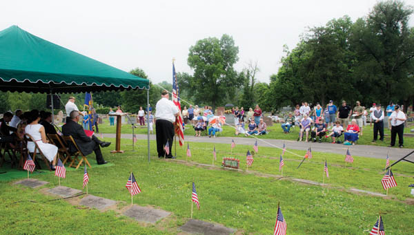 Area residents convene at the Soldiers Plot at Woodland Cemetery as they take part in the annual Veterans Memorial Service Sunday.