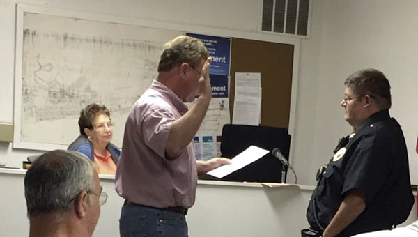 Chesapeake Mayor Tommy Templeton swears in Lenny Abrams as the village’s new police chief at a meeting of council on Monday.
