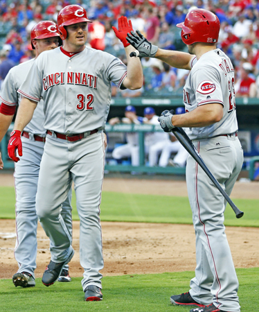 The Cincinnati Reds’ Jay Bruce (32) celebrates his three-run home run with Adam Duvall against the Texas Rangers during the first inning on Tuesday at Globe Life Park in Arlington, Texas. The Reds beat the Rangers 8-2. (Jim Cowsert/Fort Worth Star-Telegram/TNS)