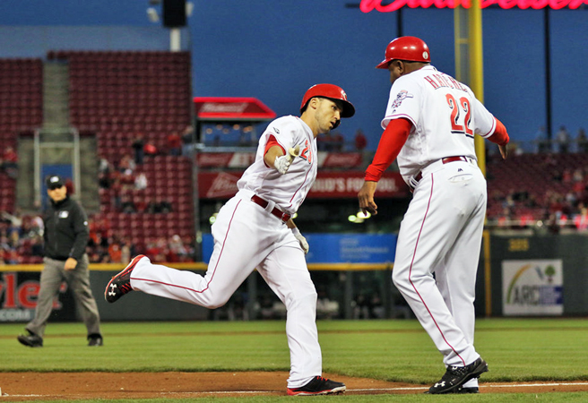Cincinnati Reds’ Adam Duvall (left) is congratulated by third base coach Billy Hatcher after he hit his 21st home run in a 7-4 loss to the San Diego Padres on Thursday. (Courtesy of the Cincinnati Reds.com/Gary Landers — AP Photo)