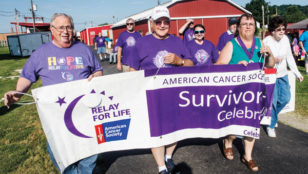 Participants in Friday evening’s Relay for Life walk the survivors’ lap at the start of the event at the Lawrence County Fairgrounds.