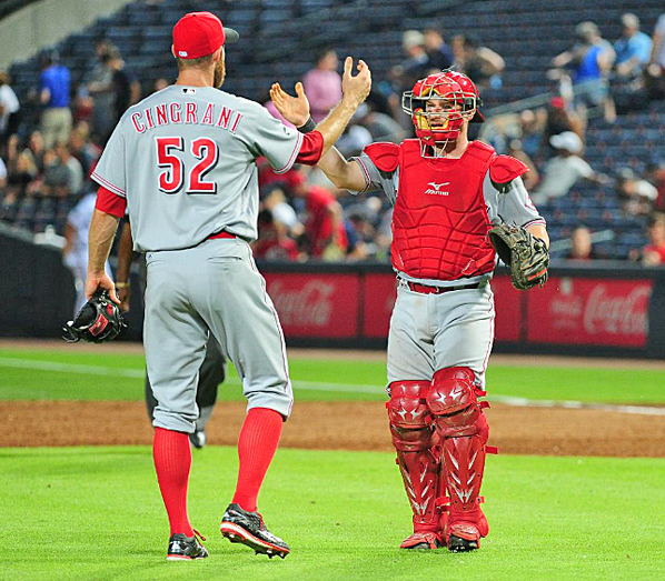 Cincinnati Reds’ reliever Tony Cingrani (52) and catcher Tucker Barnhart congratulate each other after beating the Atlanta Braves 9-8 on Monday. (Courtesy of The Cincinnati Reds.com/Scott Cunningham — Getty Images)