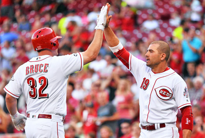 Cincinnati’s Joey Votto (19) congratulates Jay Bruce after he hit a two-run homer in the first inning of Tuesday’s game. The Reds lost to the Atlanta Braves 5-4 in 11 innings. (Courtesy of The Cincinnati Reds.com/Jamie Sabau - Getty Images)