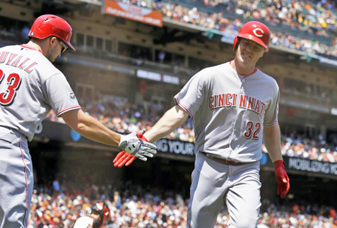 Cincinnati’s Jay Bruce (32) is congratulated by Adam Duvall after hitting a solo home run in the seventh inning of Wednesday’s game. The home run marked the fifth straight game Bruce has homered and it gave the Reds a 2-1 win over the San Francisco Giants. (Photo Courtesy of The Cincinnati Reds.com/Eric Riseberg — Associated Press)