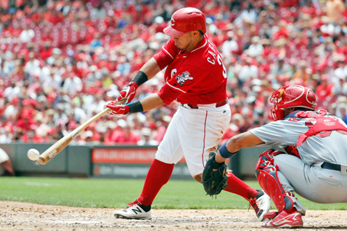 Cincinnati catcher Ramon Cabrera gets an RBI single off St. Louis Cardinals’ reliever Seth Maness in the sixth inning of Thursday afternoon’s game. Cabrera had three RBIs as the Reds blanked the Cardinals 7-0. (Photo Courtesy of The Cincinnati Reds.com/Jon Minchillo – Associated Press)
