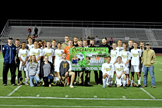 Current and former South Point Pointers soccer players surround coach Zane Joy after being presented a banner honoring him for his 100th career win when they beat Wheelersburg last Thursday. The Pointers downed Rock Hill on Tuesday. (Kent Sanborn of Southern Ohio Sports Photos)