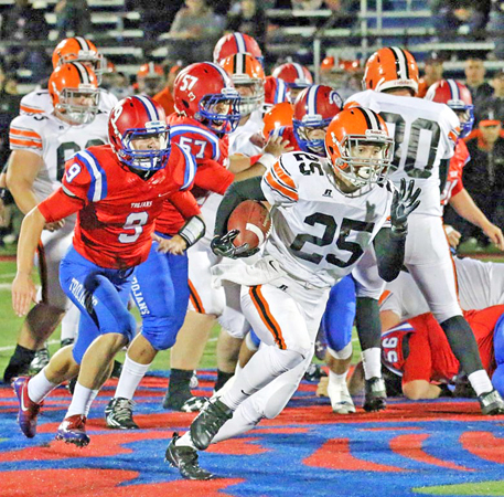 Ironton Fighting Tigers’ Jourdyn Barrow (25) outruns Portsmouth Trojans’ Luke Purdy en route to an 18-yard gain during last week’s game. Ironton travels to Coshocton at 7 p.m. on Saturday in the Division V Region 19 playoff quarterfinals. (Tim Gearhart of Tim's News & Novelties on Park Ave., Ironton)