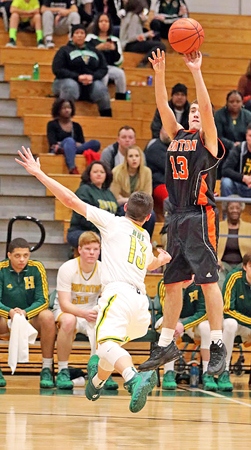 Ironton Fighting Tigers’ guard Joel Blankenship (right) hits a 3-point goal over Huntington’s Grant Subik during Wednesday’s game. Ironton fell to the Highlanders 57-44. (Tim Gearhart of Tim’s News & Novelties, Park Ave. in Ironton)