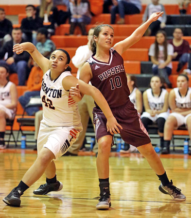 Ironton Lady Fighting Tigers’ Taiya Hamlet (42) battles with Russell Lady Red Devils’ Madison Darnell (10) for rebounding position during Thursday’s game. Russell held off a late rally by Ironton to post a 65-54 win. (Tim Gearhart of Tim’s News & Novelties, Park Ave. in Ironton)