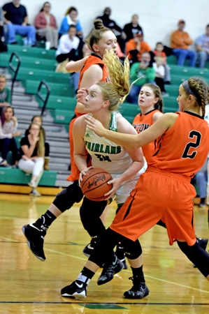 Fairland Lady Dragons’ center Alesha Simpson (34) looks to go up between Ironton Lady FIghting Tigers’ defenders Lexie Arden and Lydia Hannan (2) during Thursday’s Ohio Valley Conference game. Fairland got the win 49-41. (Kent Sanborn of Southern Ohio Sports Photos)