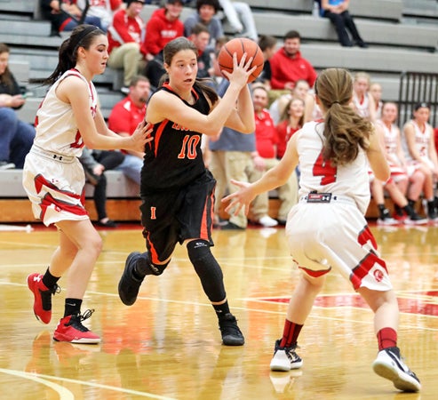 Ironton Lady Fighting Tigers’ Riley Schreck drives toward the basket during Monday’s game at Rock Hill. Ironton got the OVC over the Redwomen. (Tim Gearhart of Tim’s News & Novelties, Park Ave. in Ironton)