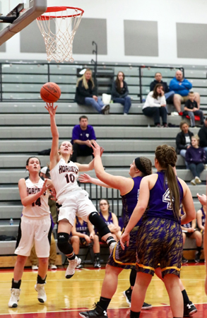 Coal Grove Lady Hornets’ Emily Compliment is fouled and falls backward but still manages to get of the shot during Wednesday’s Division III sectional tournament game against Lucasville Valley. The Lady Hornets won 43-22. (Tim Gearhart of Tim’s News & Novelties, Park Ave. in Ironton)