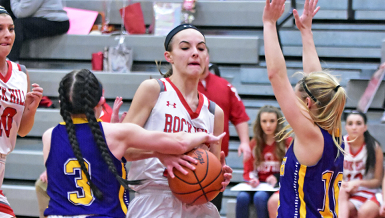 Rock Hill Redwomen’s Caitlynn Meadows looks to split St. Joseph defenders Kaitlyn Sheridan (3) and Morgan Turner (right) during Wednesday’s game. Rock Hill won 49-23. (Kent Sanborn of Southern Ohio Sports Photos)