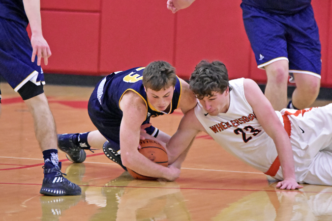 South Point Pointers’ Jared Whitt (left) and Wheelersburg Pirates’ Kaden Coleman (right) battle for a loose ball during Saturday’s Division III sectional championship game. The Pointers beat the Pirates 70-63 and will play Sunday in the district tournament at Athens. (Kent Sanborn of Southern Ohio Sports Photos)