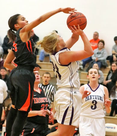 Ironton Lady Fighting Tigers’ Lexi Wise (left) blocks the shot of Chesapeake Lady Panthers’ Natalee Hall during Thursday’s game. Ironton won 47-32. (Tim Gearhart of Tim’s News & Novelties, Park Ave. in Ironton)