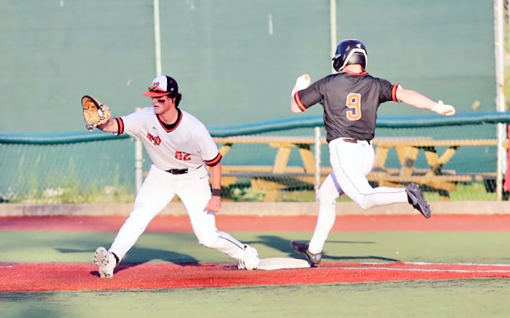 Ironton Fighting Tigers' Trevor Kleinman (9) just misses out an infield hit as he in an infield system. Kleinman's foot is just shy of the base while the ball just hits into the math. (Tim Gearhart Photo for The Ironton Tribune)